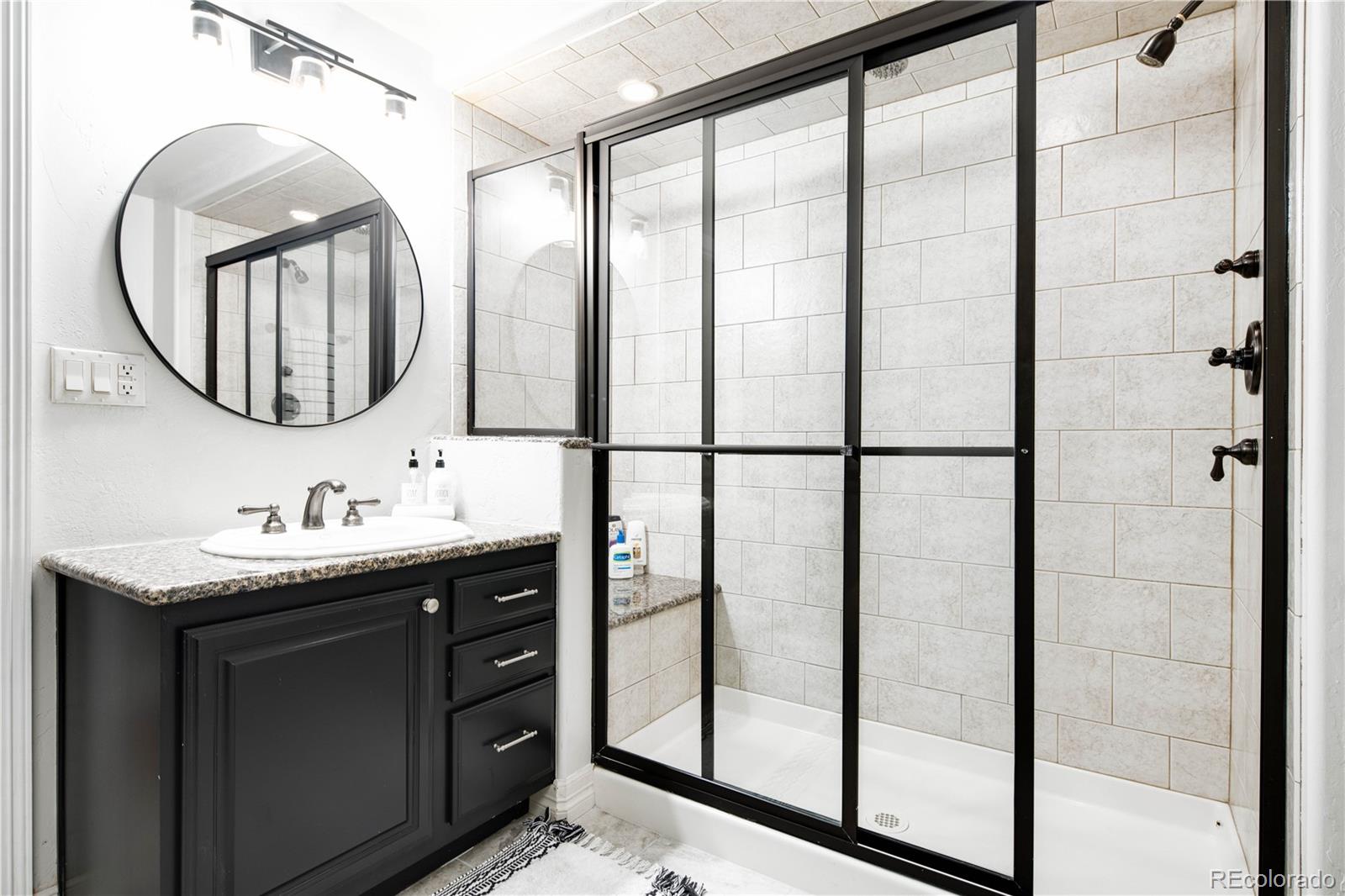 1 Ravenswood Road Cherry Hills Village, CO 80113 - Photo 27 of 40 a bathroom with a mirror a sink and a mirror
