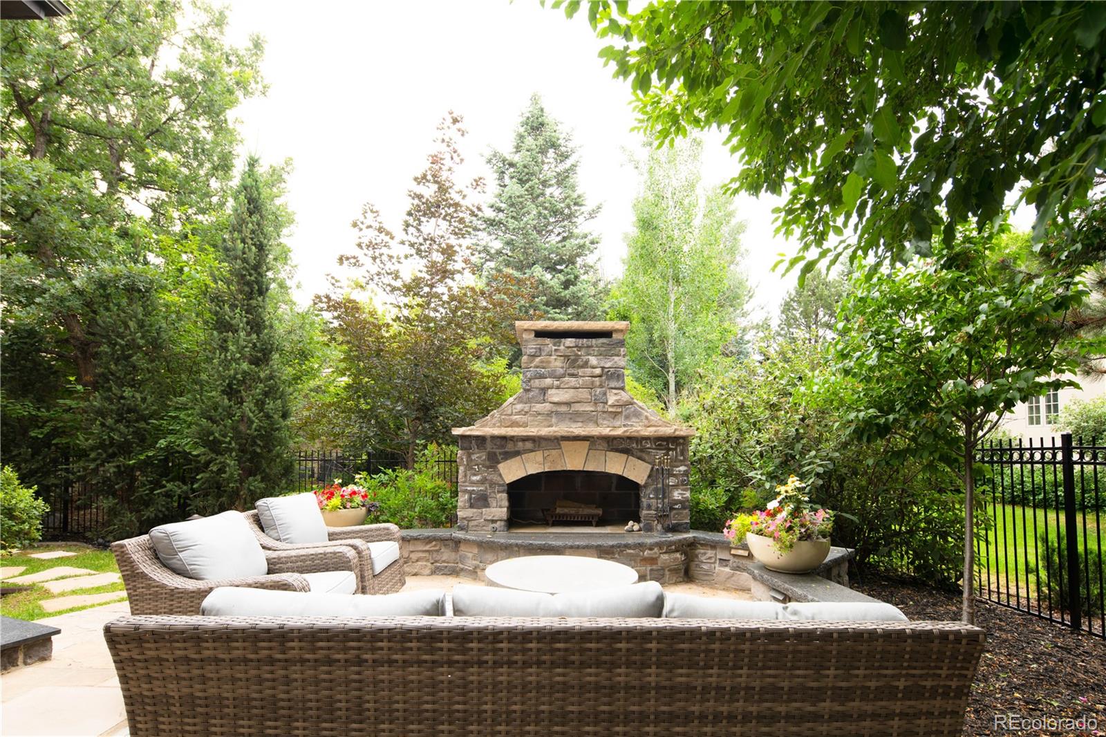 1 Ravenswood Road Cherry Hills Village, CO 80113 - Photo 35 of 40 a view of a patio with couches table and chairs and potted plants