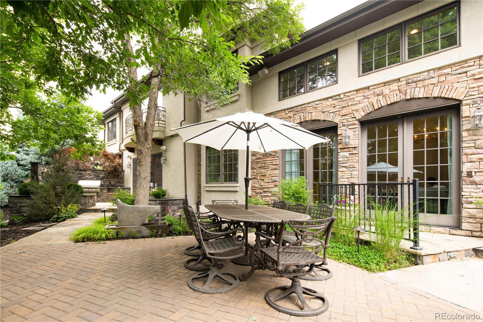 1 Ravenswood Road Cherry Hills Village, CO 80113 - Photo 36 of 40 a view of a chair and table in backyard of the house
