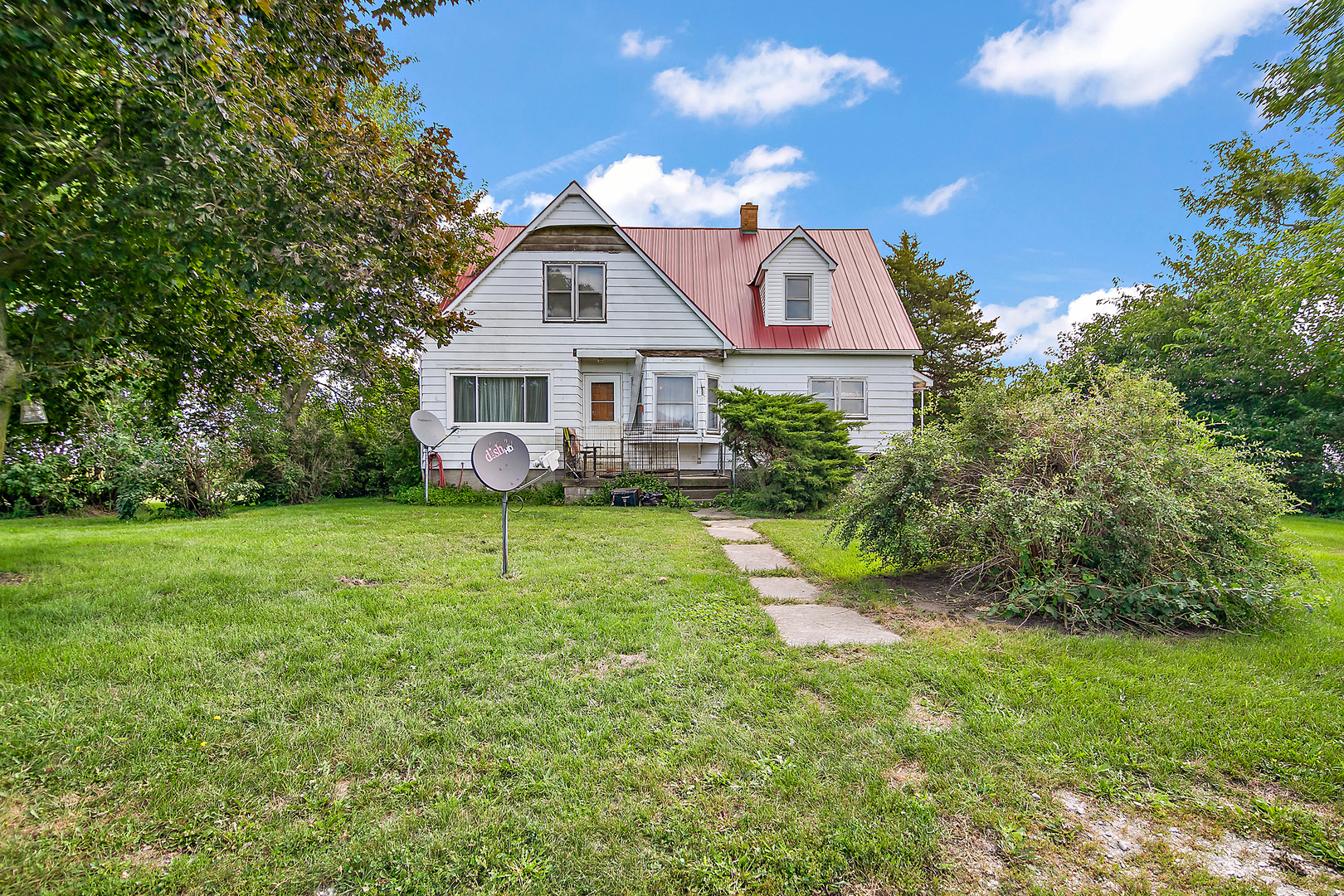 a front view of house with yard and green space
