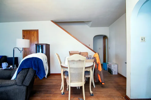 a dining room with furniture and wooden floor