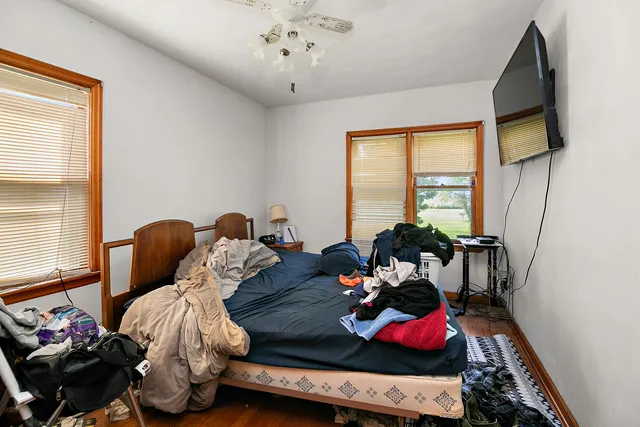 a bedroom with furniture and a large window