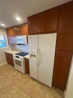 a kitchen with a cabinets and white stainless steel appliances