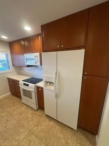 a kitchen with a cabinets and white stainless steel appliances