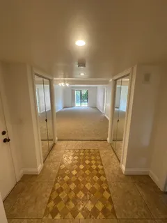 a view of a bedroom with wooden floor and bathroom