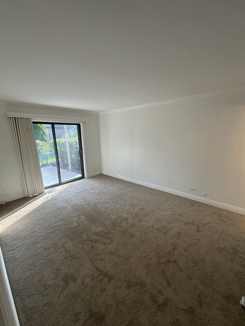 1721 Northfield Square, Unit B Northfield, IL 60093 - Photo 10 of 16 a view of an empty room with a window