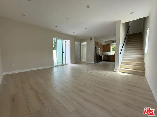 a kitchen with stainless steel appliances a refrigerator sink and cabinets