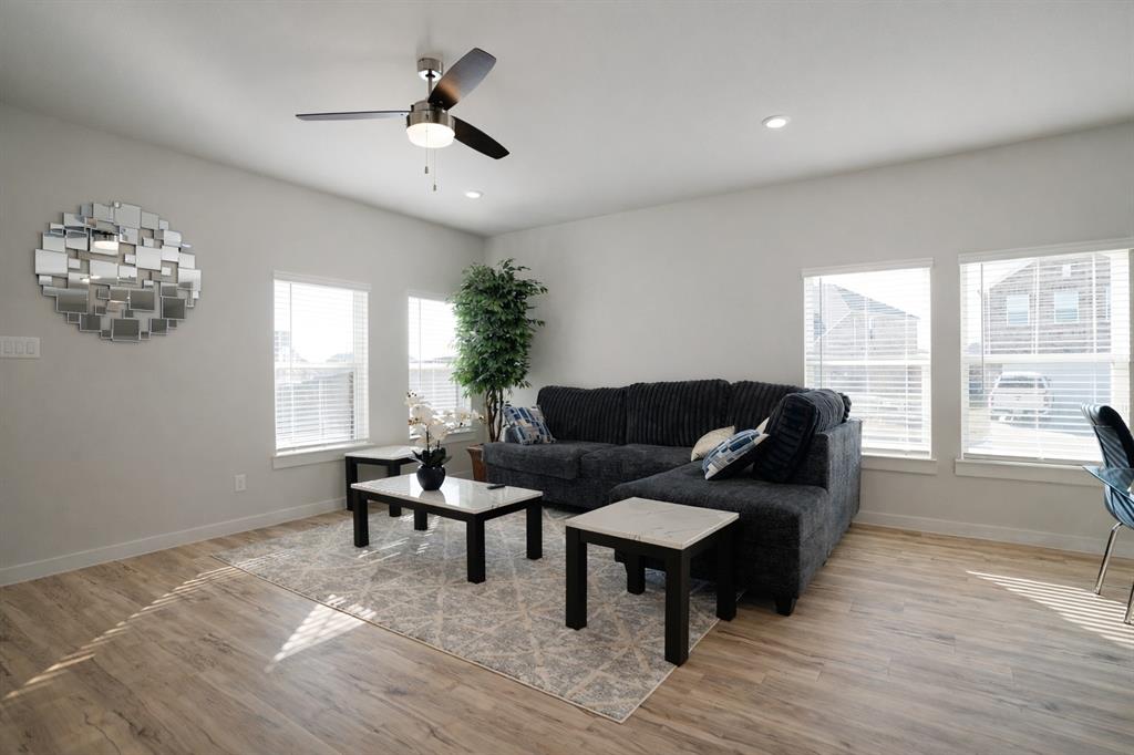 655 Scarlett Street Forney, TX 75126 - Photo 11 of 24 Living area with light wood finished floors, healthy amount of natural light, ceiling fan, and recessed lighting