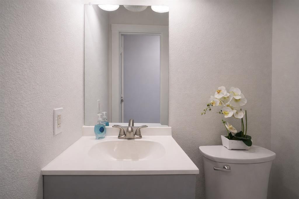 655 Scarlett Street Forney, TX 75126 - Photo 13 of 24 Half bathroom with a textured wall and vanity