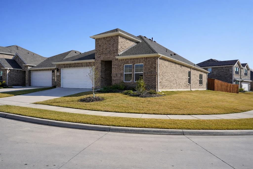 655 Scarlett Street Forney, TX 75126 - Photo 2 of 24 View of front of property with brick siding, concrete driveway, a garage, and a shingled roof