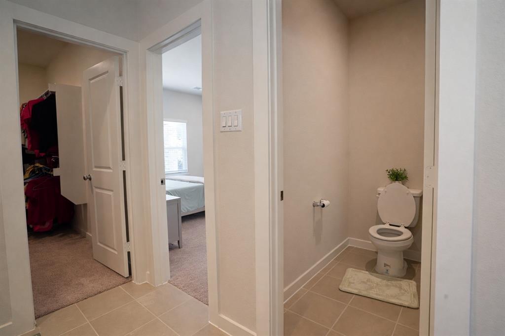 655 Scarlett Street Forney, TX 75126 - Photo 21 of 24 Bathroom featuring light tile patterned floors, ensuite bathroom, and light carpet