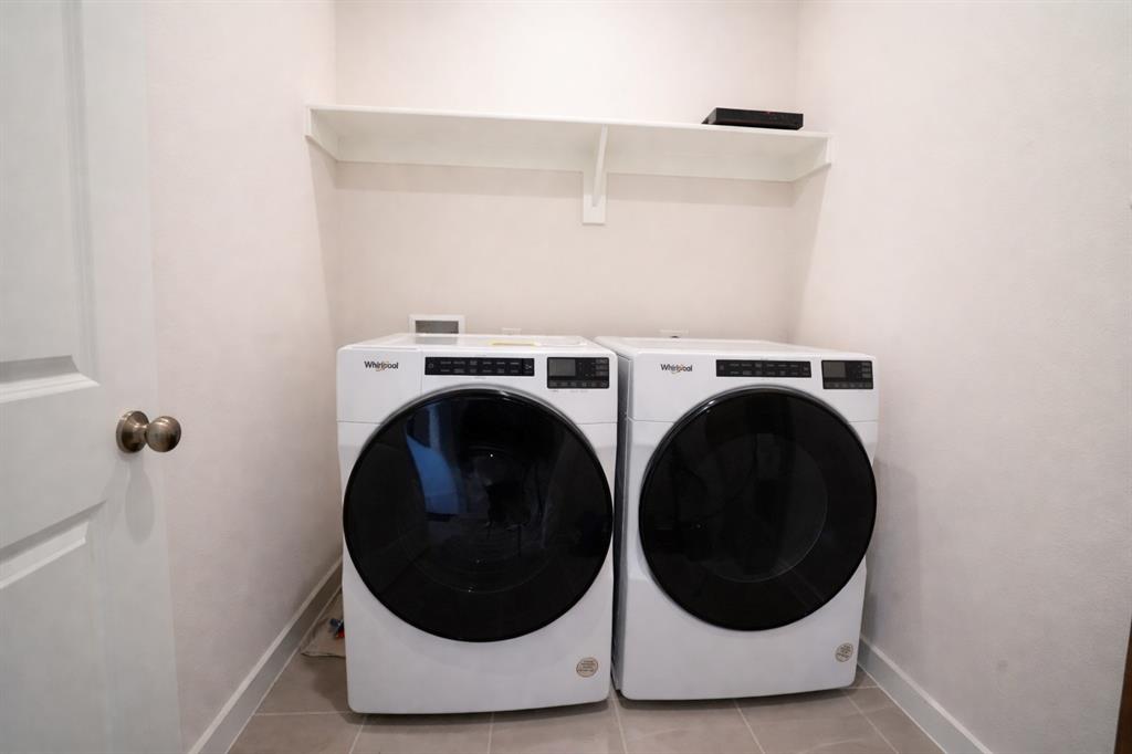 655 Scarlett Street Forney, TX 75126 - Photo 22 of 24 Washroom with light tile patterned floors and washer and clothes dryer