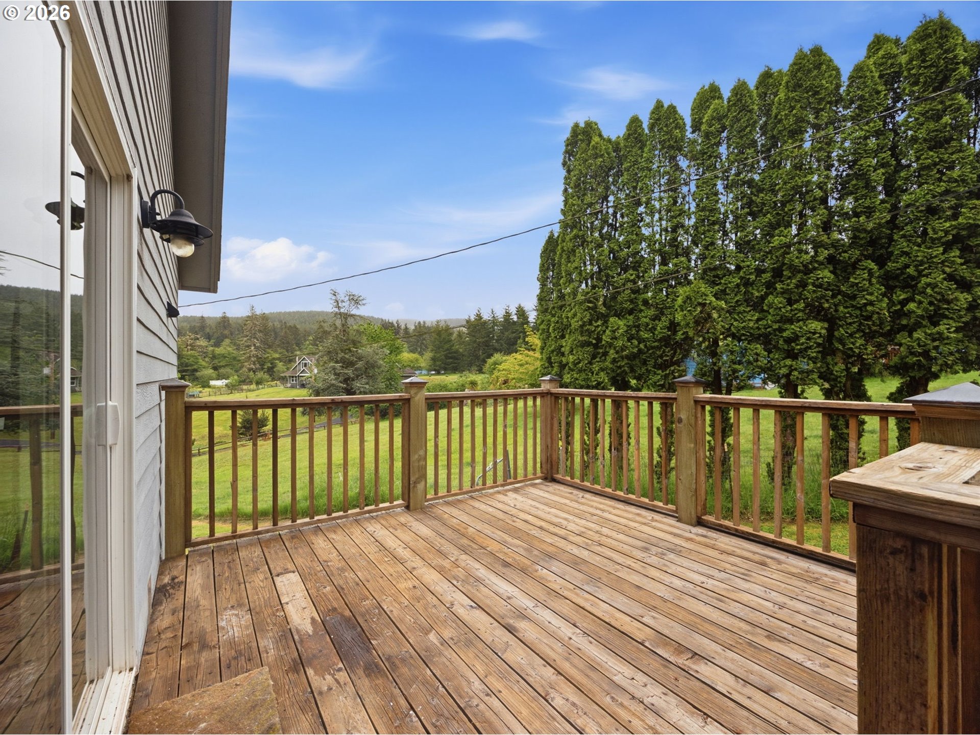 92085 Akerstedt Road Astoria, OR 97103 - Photo 40 of 48 a balcony with wooden floor next to a yard