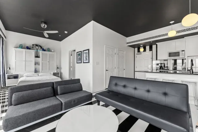 a bedroom with a bed and a large mirror on the dresser