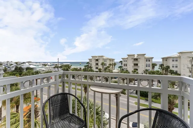 a view of a house with a yard and potted plants