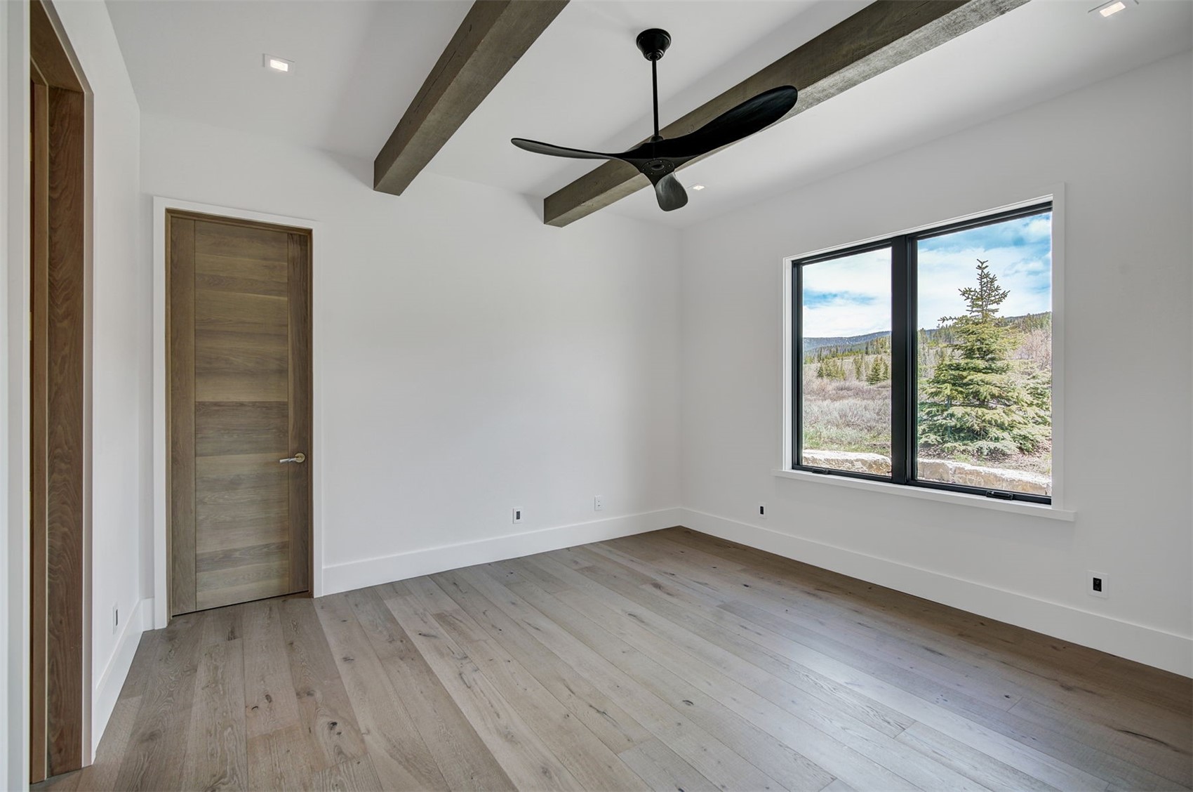 294 Gold Run Road Breckenridge, CO 80424 - Photo 31 of 49 an empty room with wooden floor cabinet and windows