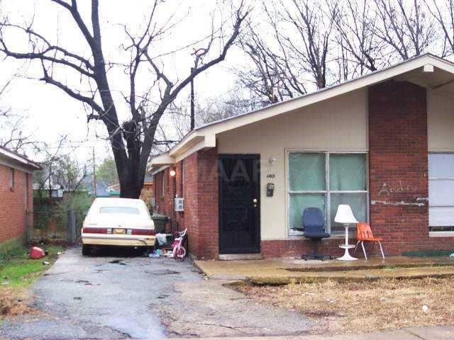 View of exterior entry featuring brick siding and driveway
