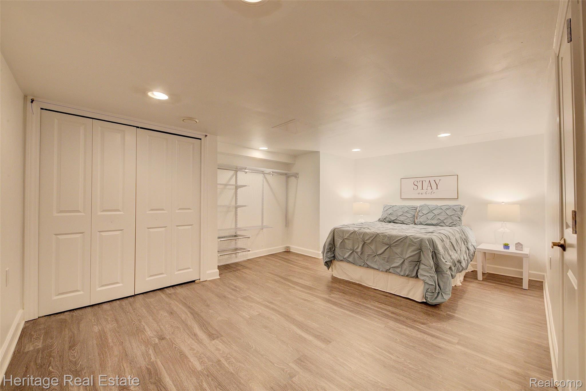 654 Old Perch Road Rochester, MI 48309 - Photo 39 of 61 Spacious bedroom 4 has laminate flooring, recessed lighting and could be part of a great in-law suite! A full bath is connected to this room and a 2nd full kitchen and the laundry room are just steps away.