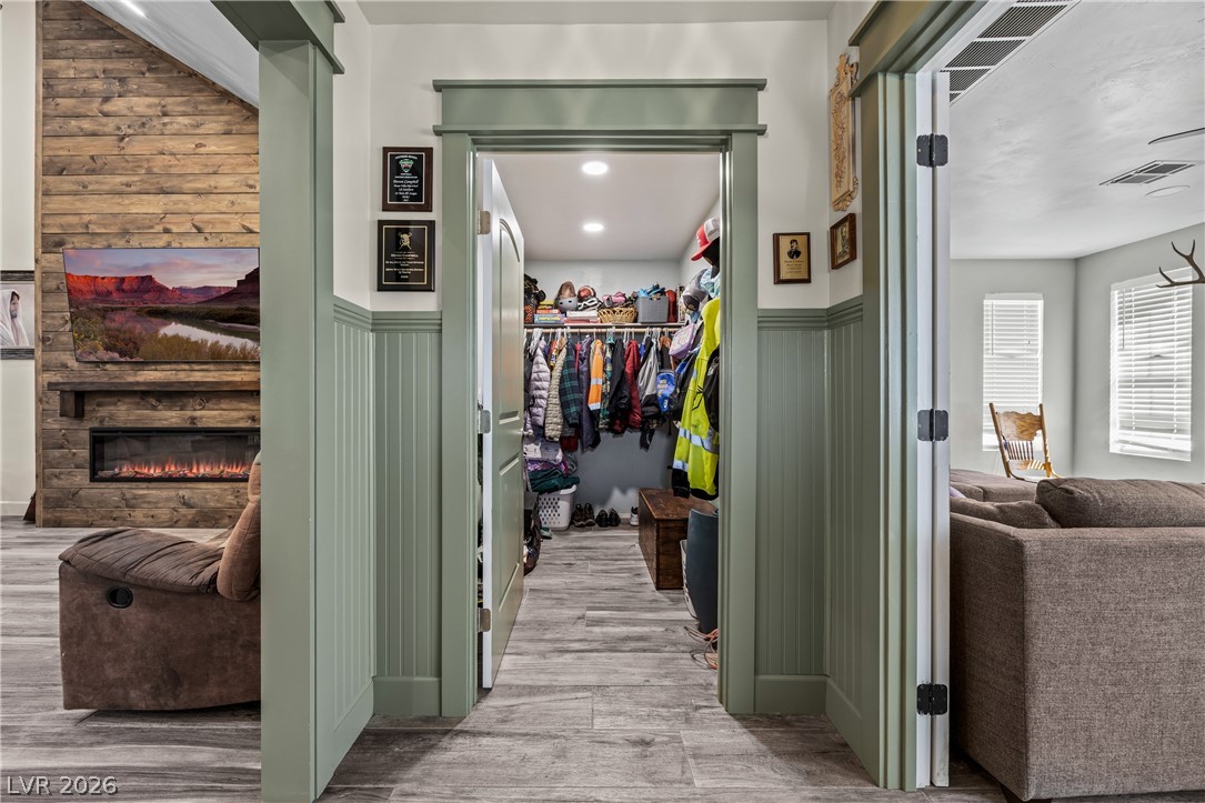 750 Leming Avenue Overton, NV 89040 - Photo 15 of 82 This living space features a cozy fireplace, wood-paneled accents, and a convenient walk-in closet.
