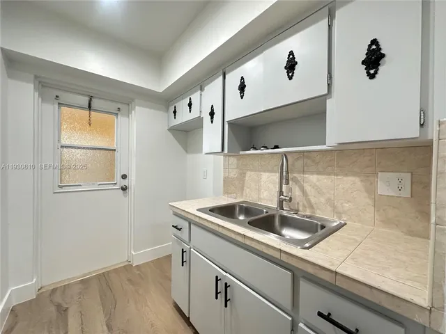 a kitchen with a sink and cabinets