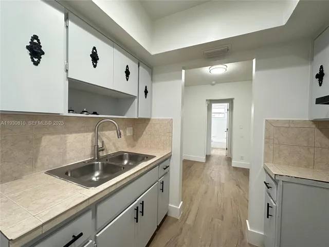 a kitchen with a sink and a refrigerator