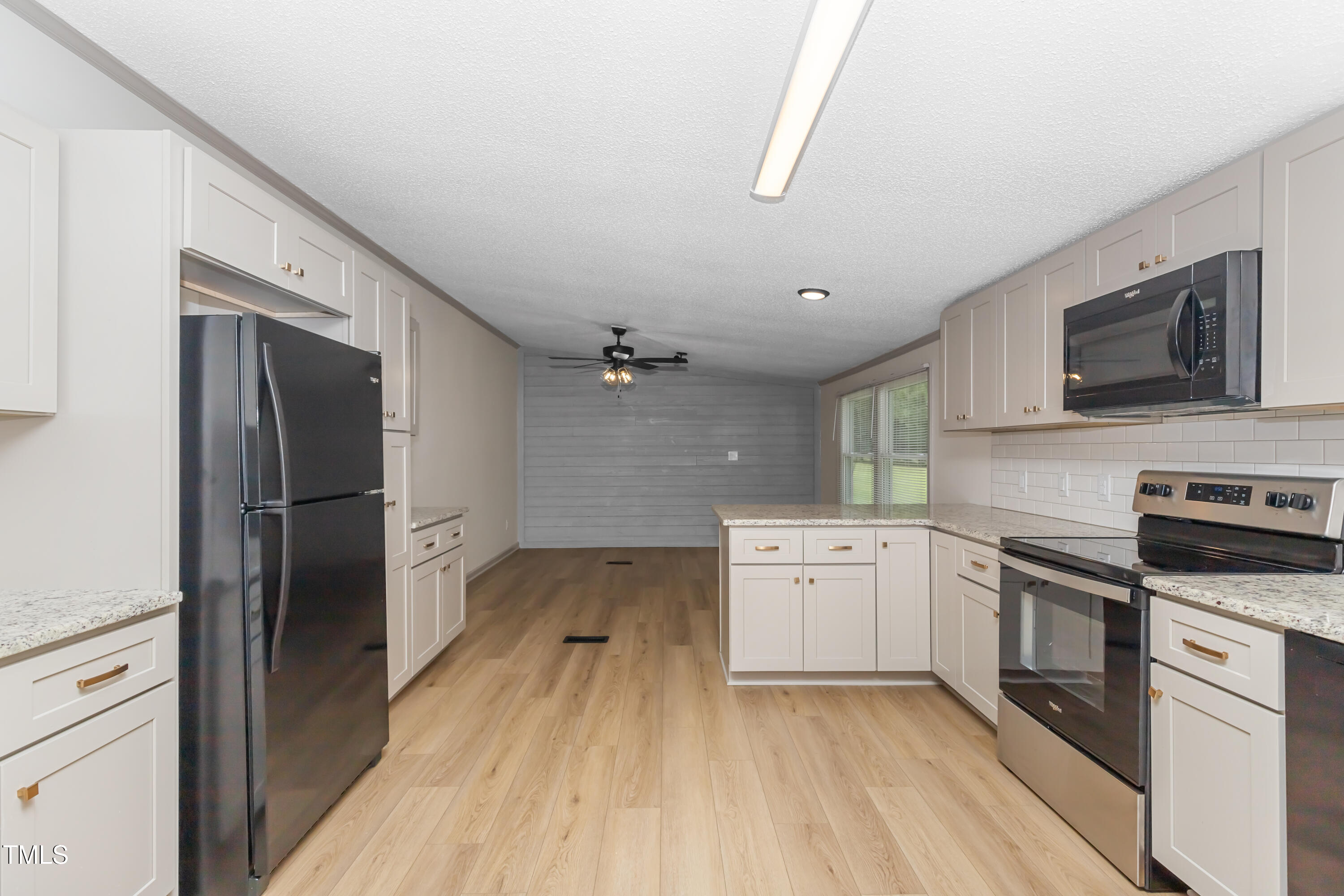 165 Dawn Road Benson, NC 27504 - Photo 12 of 30 a kitchen with a refrigerator stove and sink