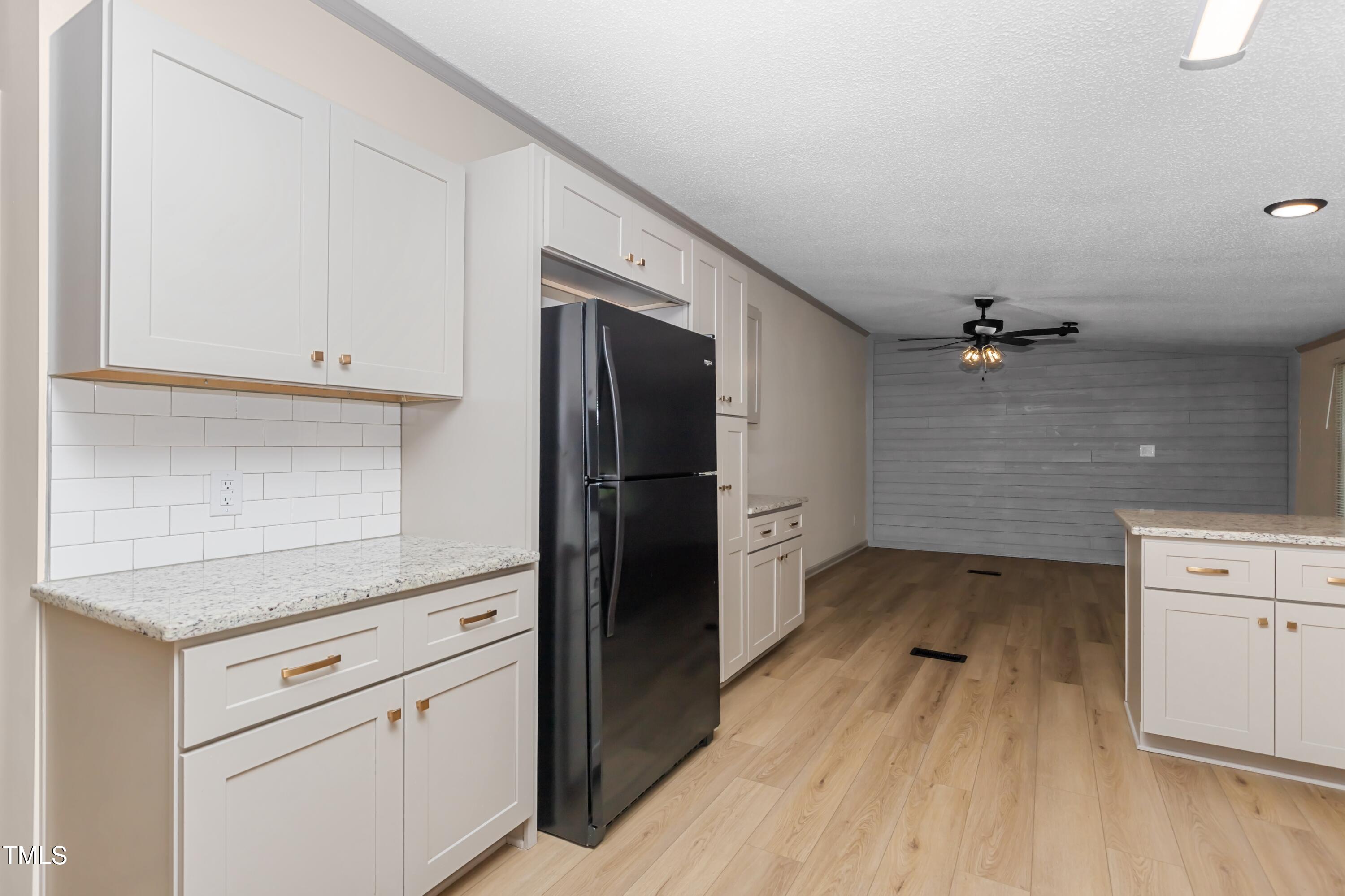 165 Dawn Road Benson, NC 27504 - Photo 14 of 30 a kitchen with a refrigerator stove and cabinets