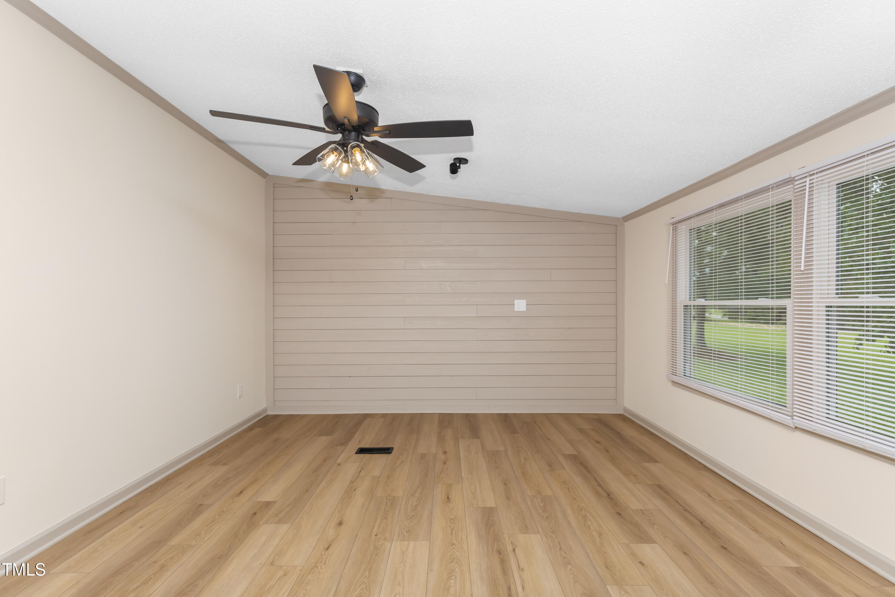165 Dawn Road Benson, NC 27504 - Photo 16 of 30 a view of empty room with wooden floor and fan