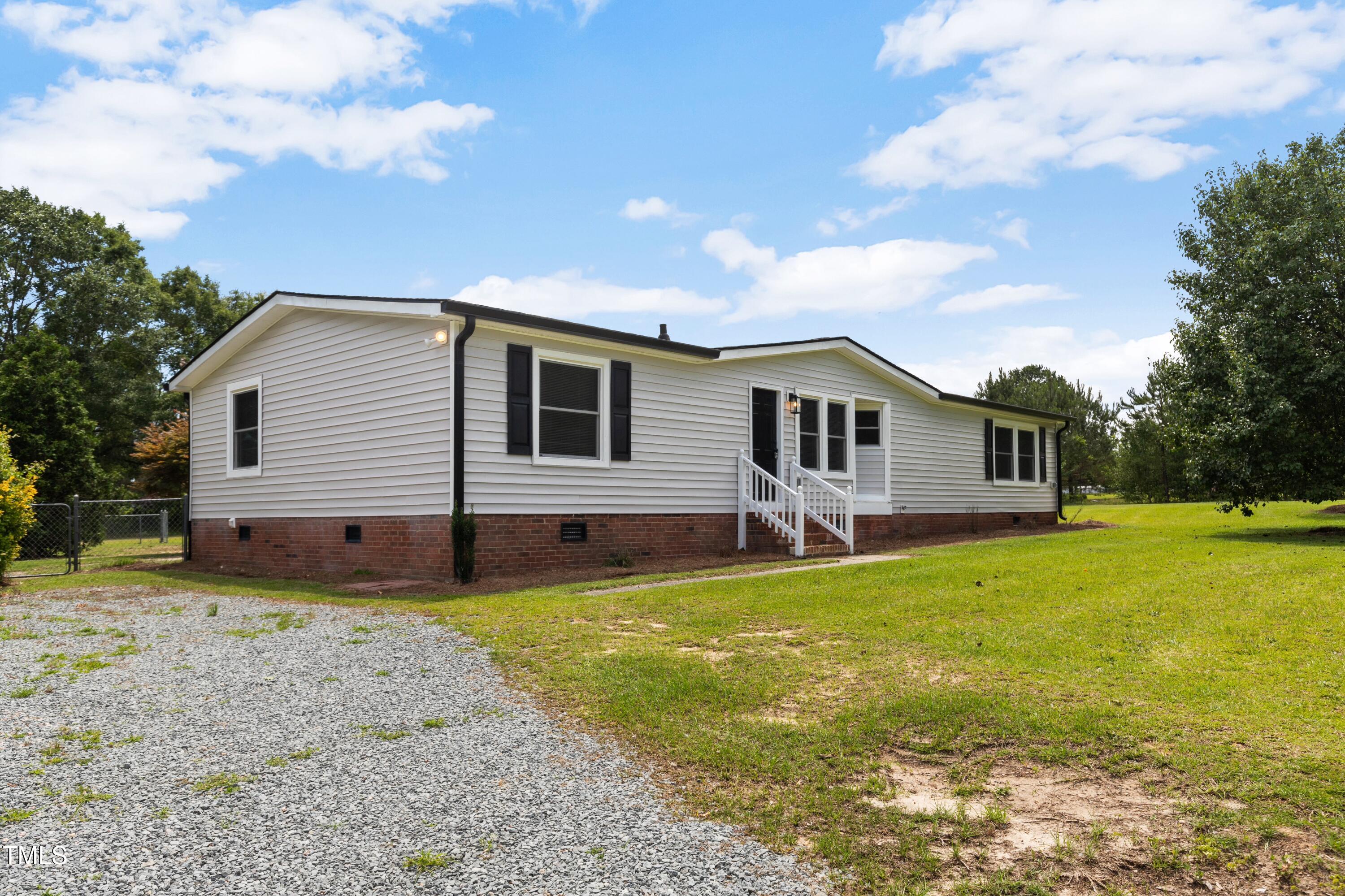 165 Dawn Road Benson, NC 27504 - Photo 2 of 30 a backyard of a house with wooden floor and fence