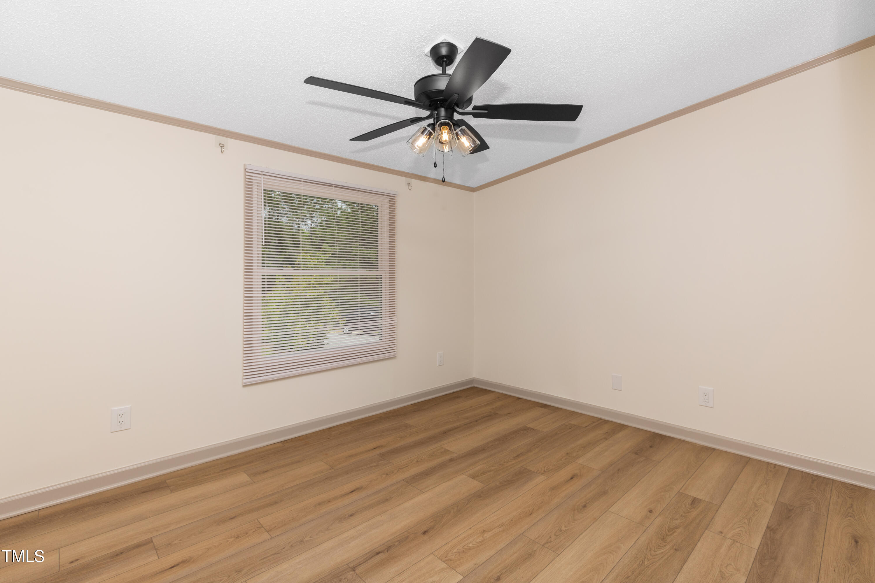 165 Dawn Road Benson, NC 27504 - Photo 24 of 30 an empty room with wooden floor a ceiling fan and windows