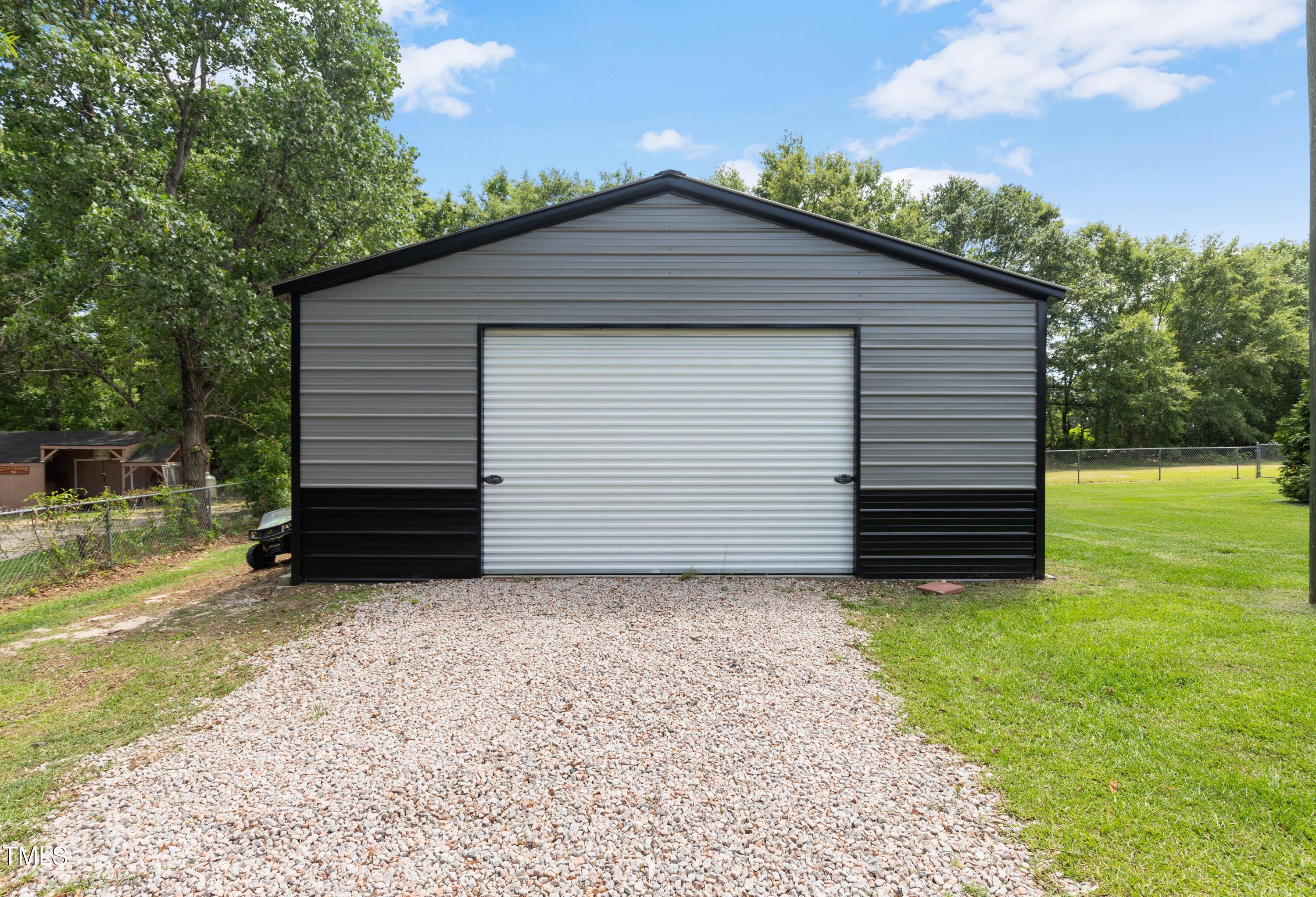 165 Dawn Road Benson, NC 27504 - Photo 26 of 30 a small white house with a white roof and wooden fence