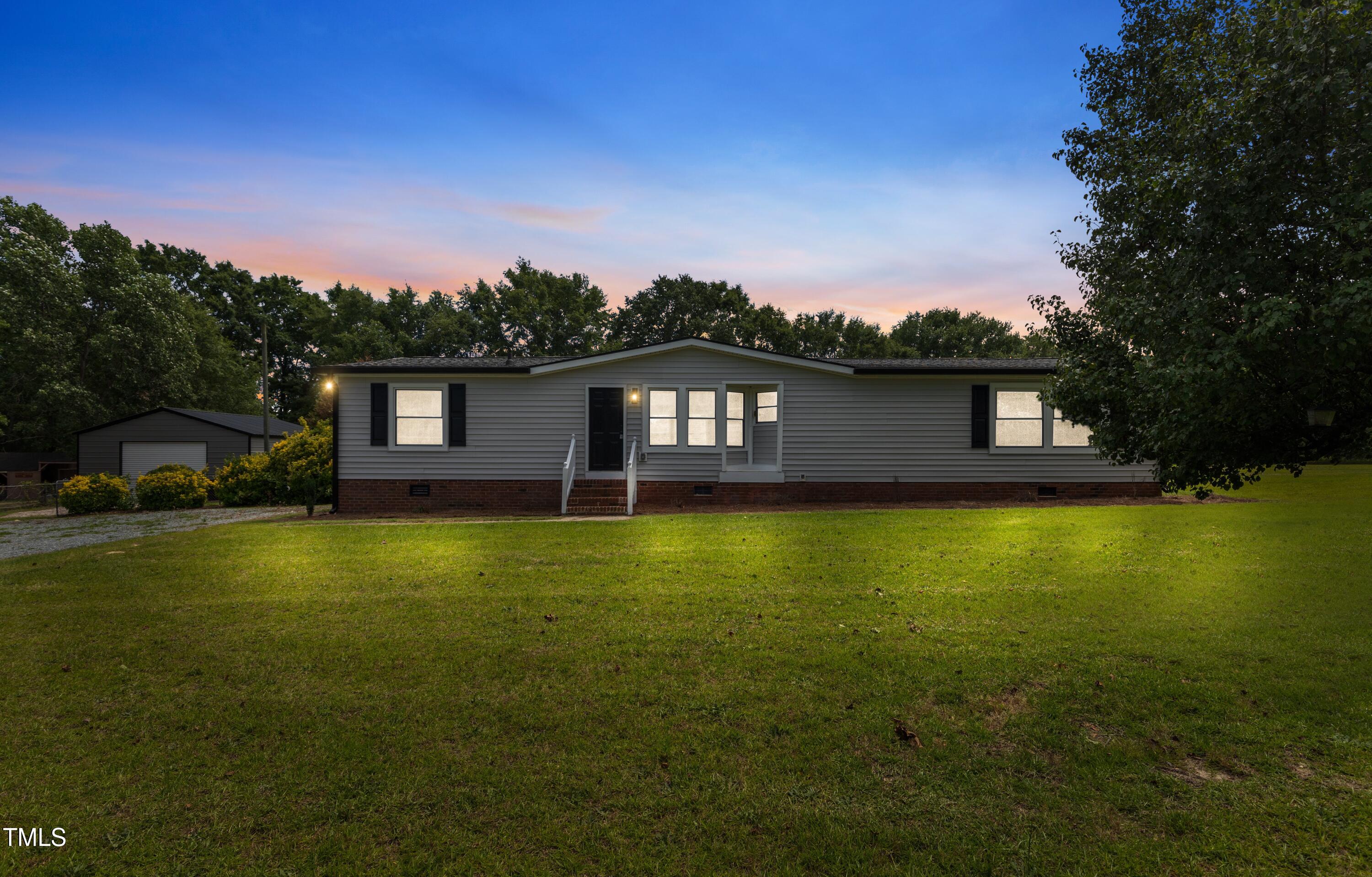 165 Dawn Road Benson, NC 27504 - Photo 3 of 30 a front view of a house with a garden