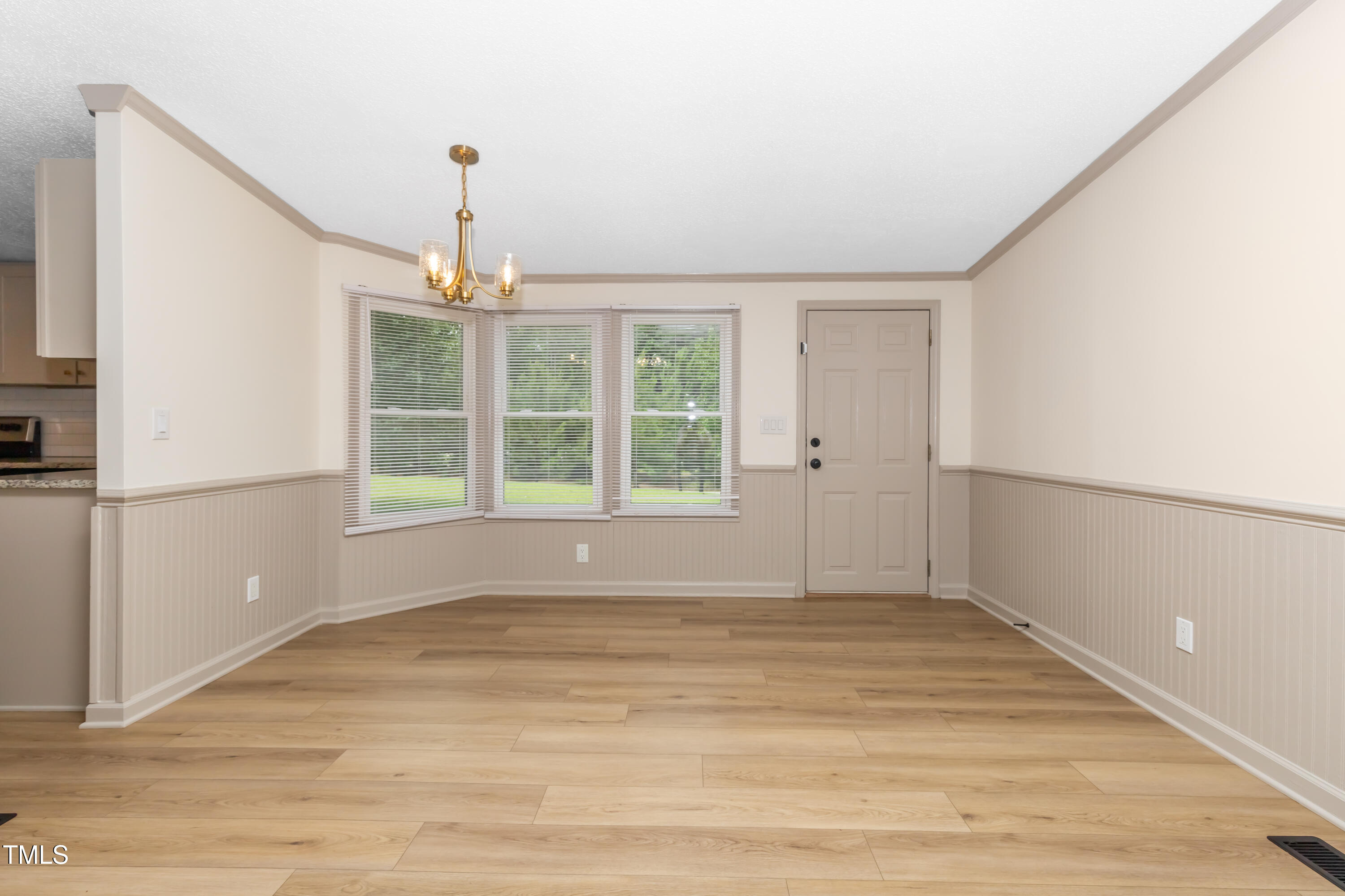 165 Dawn Road Benson, NC 27504 - Photo 6 of 30 a view of an empty room with wooden floor and a window