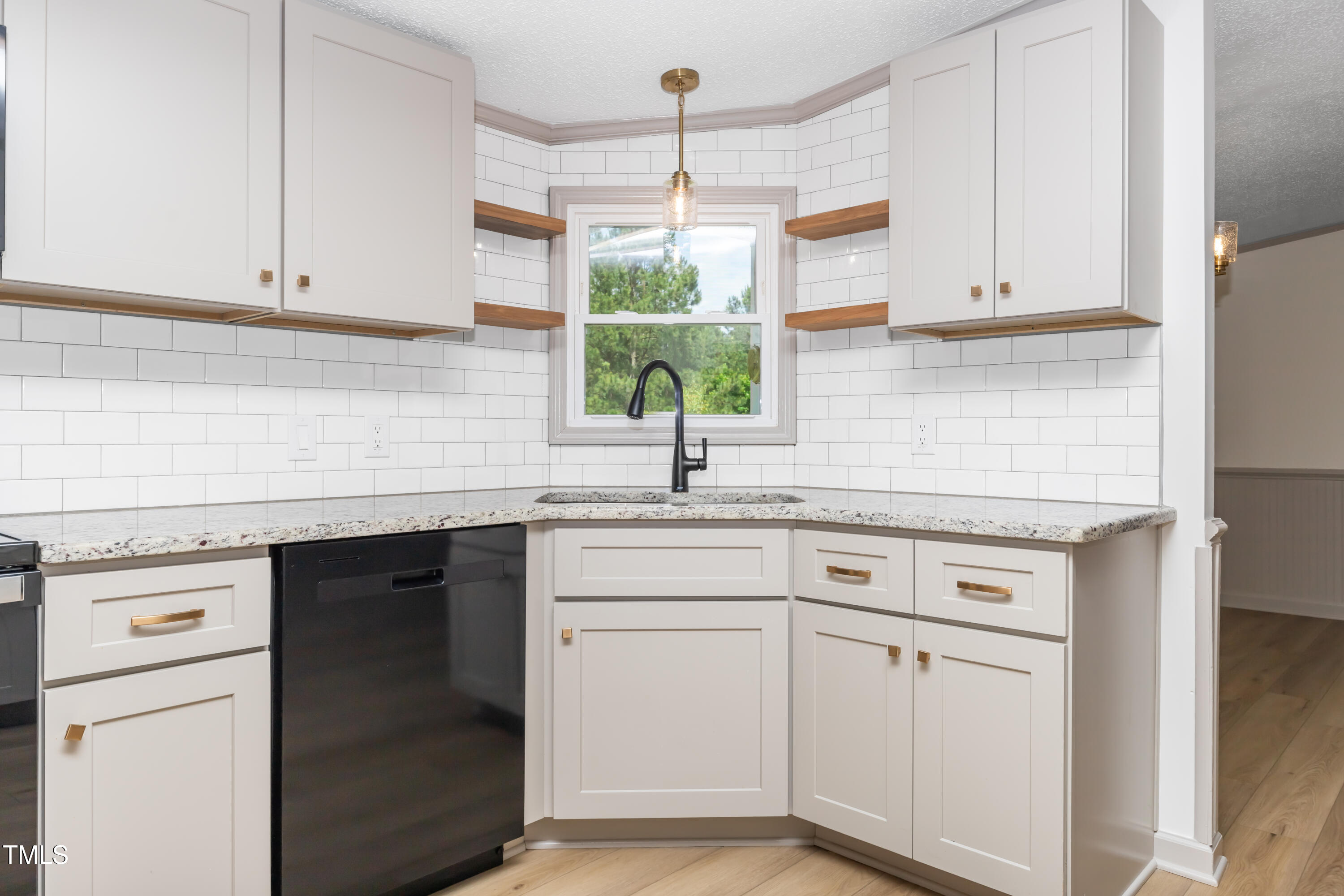 165 Dawn Road Benson, NC 27504 - Photo 9 of 30 a kitchen with white cabinets and white appliances