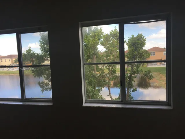 a metallic refrigerator freezer and a stove sitting inside of a kitchen