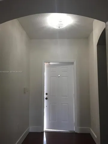 a view of an empty room and wooden floor