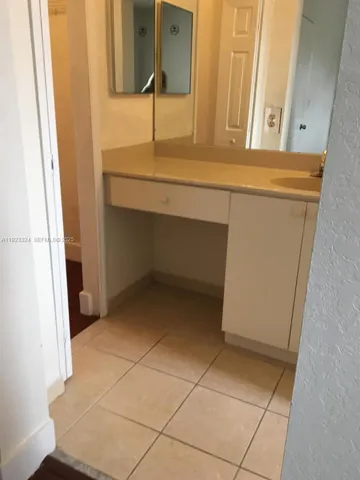 a view of walk in closet with wooden floor