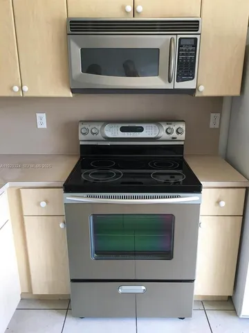 a kitchen with a stove and a microwave