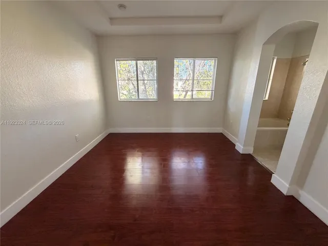 a view of room with window and wooden floor