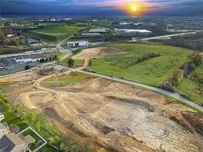 an aerial view of a house with a yard and lake view