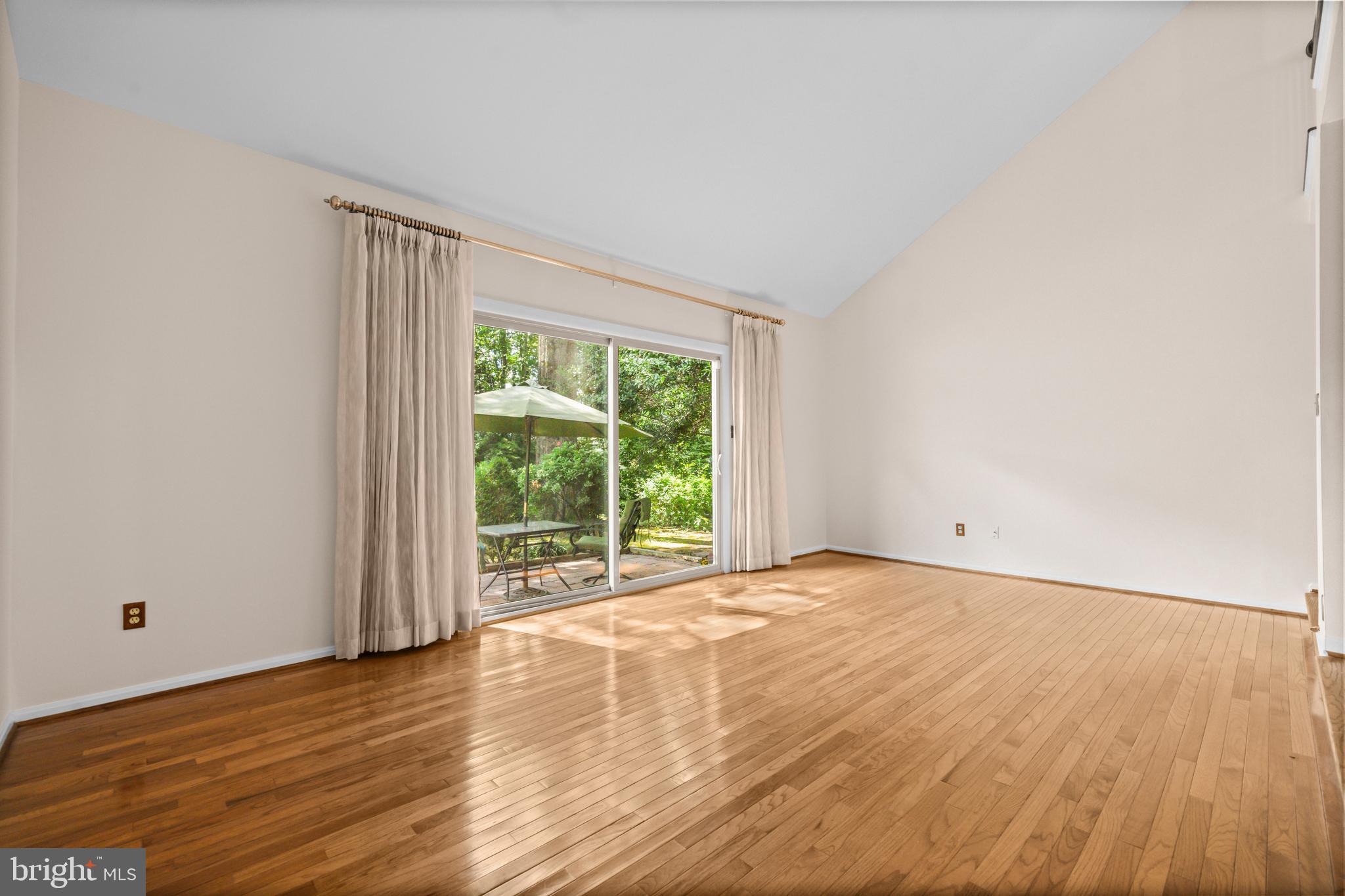 1413 Green Run Lane Reston, VA 20190 - Photo 12 of 50 a view of an empty room with wooden floor and a window