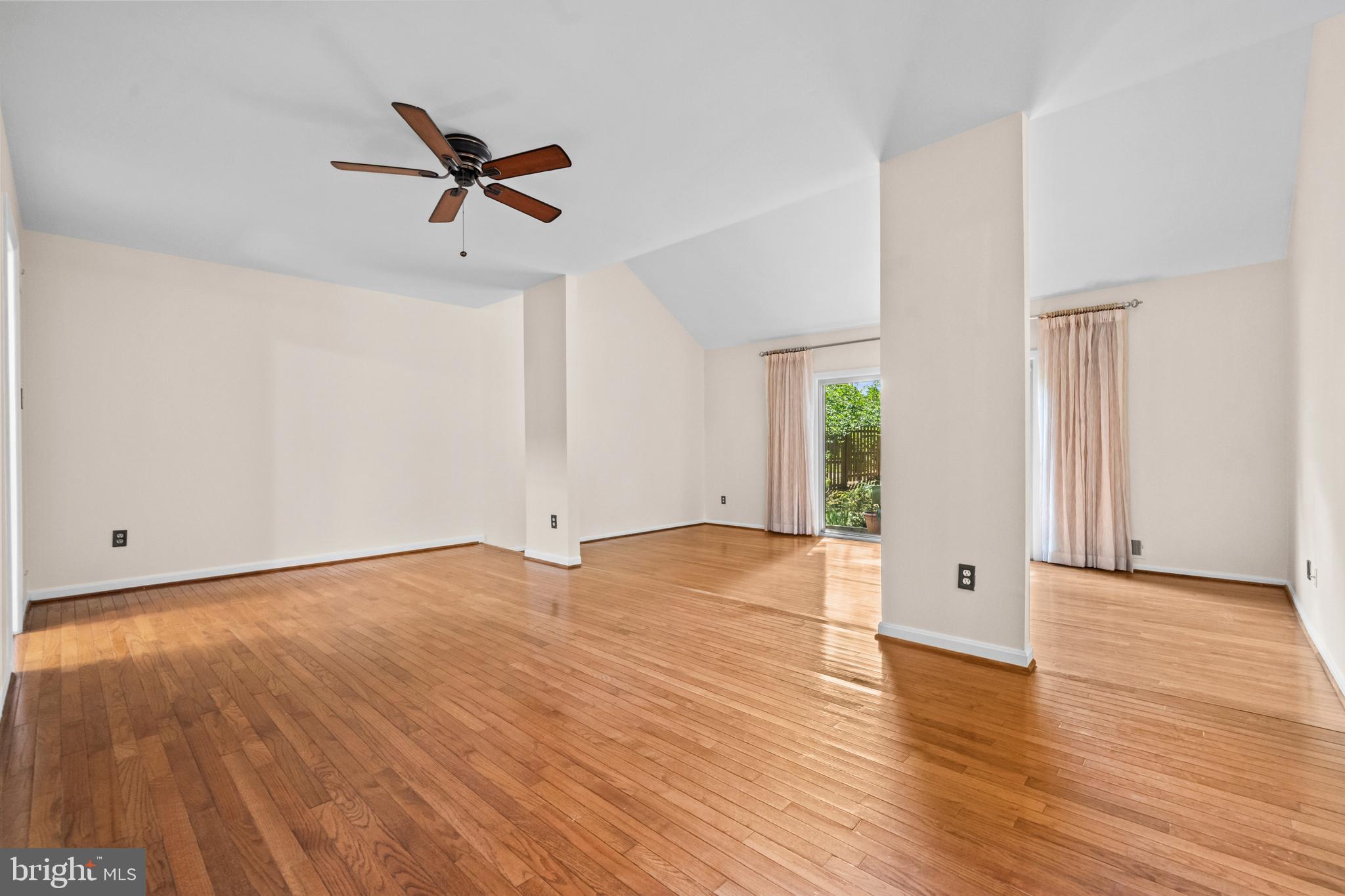 1413 Green Run Lane Reston, VA 20190 - Photo 13 of 50 an empty room with wooden floor chandelier fan and windows