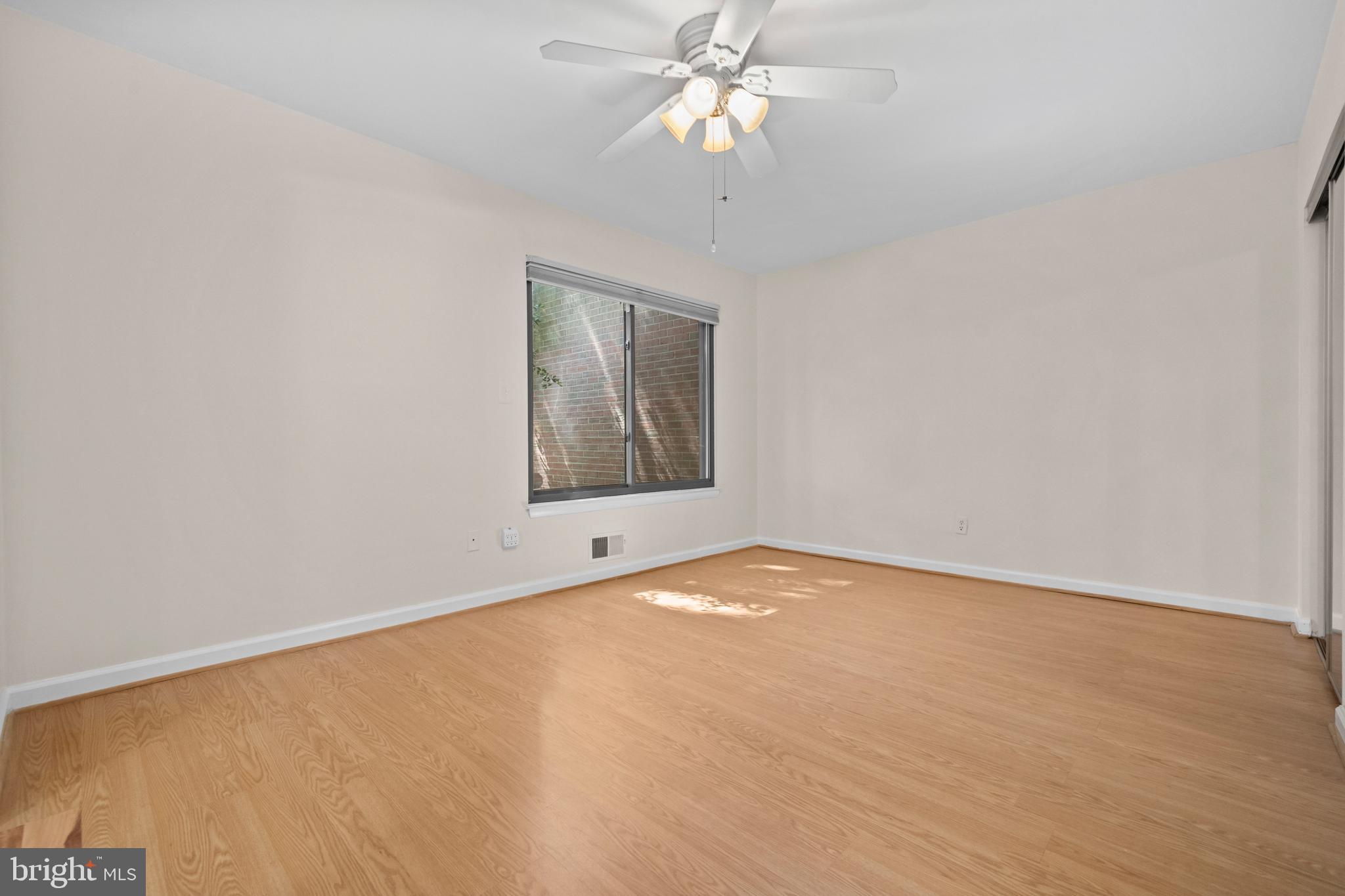 1413 Green Run Lane Reston, VA 20190 - Photo 17 of 50 an empty room with a chandelier fan and windows