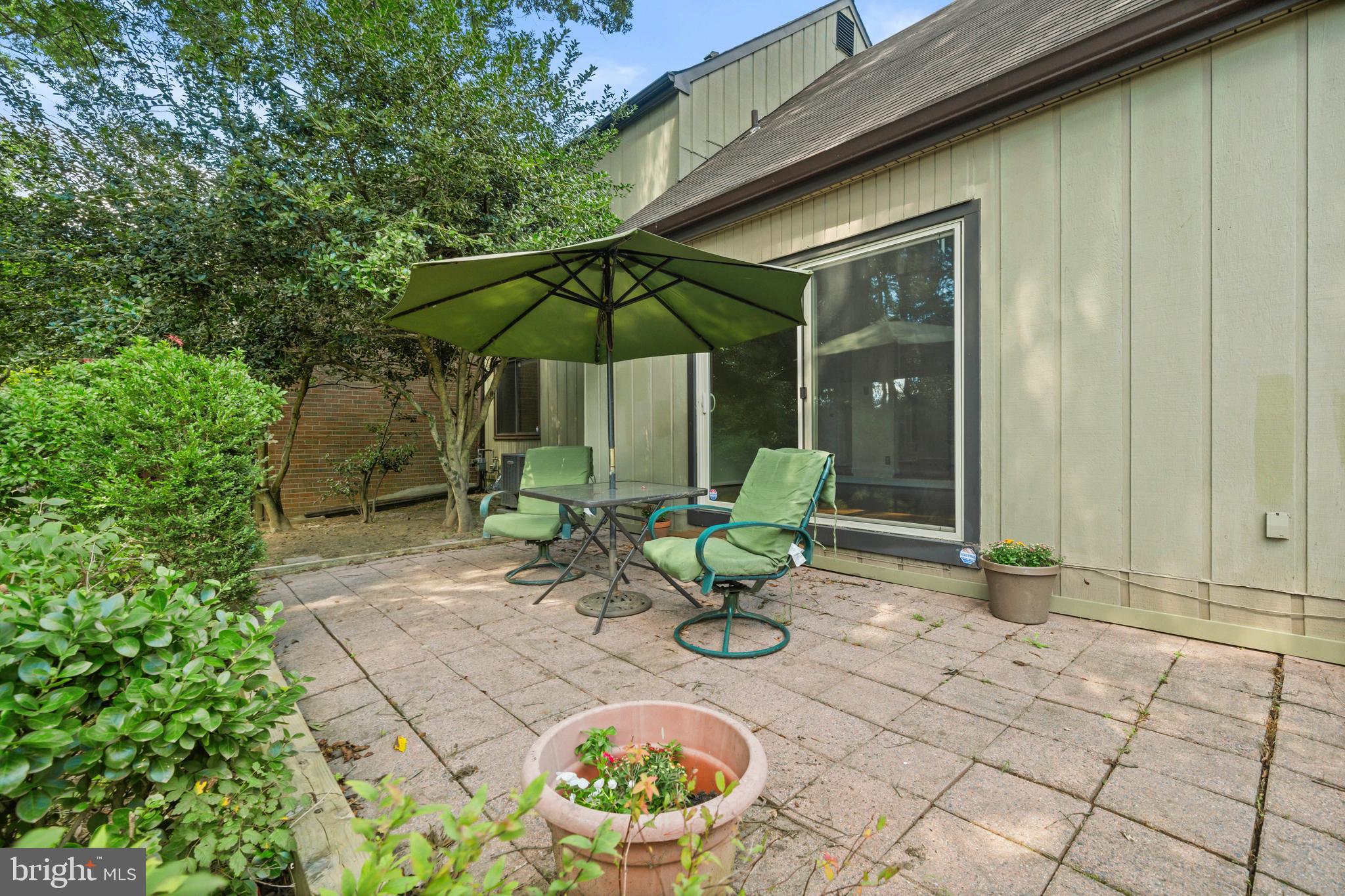 1413 Green Run Lane Reston, VA 20190 - Photo 32 of 50 a view of a chair and table in backyard of the house