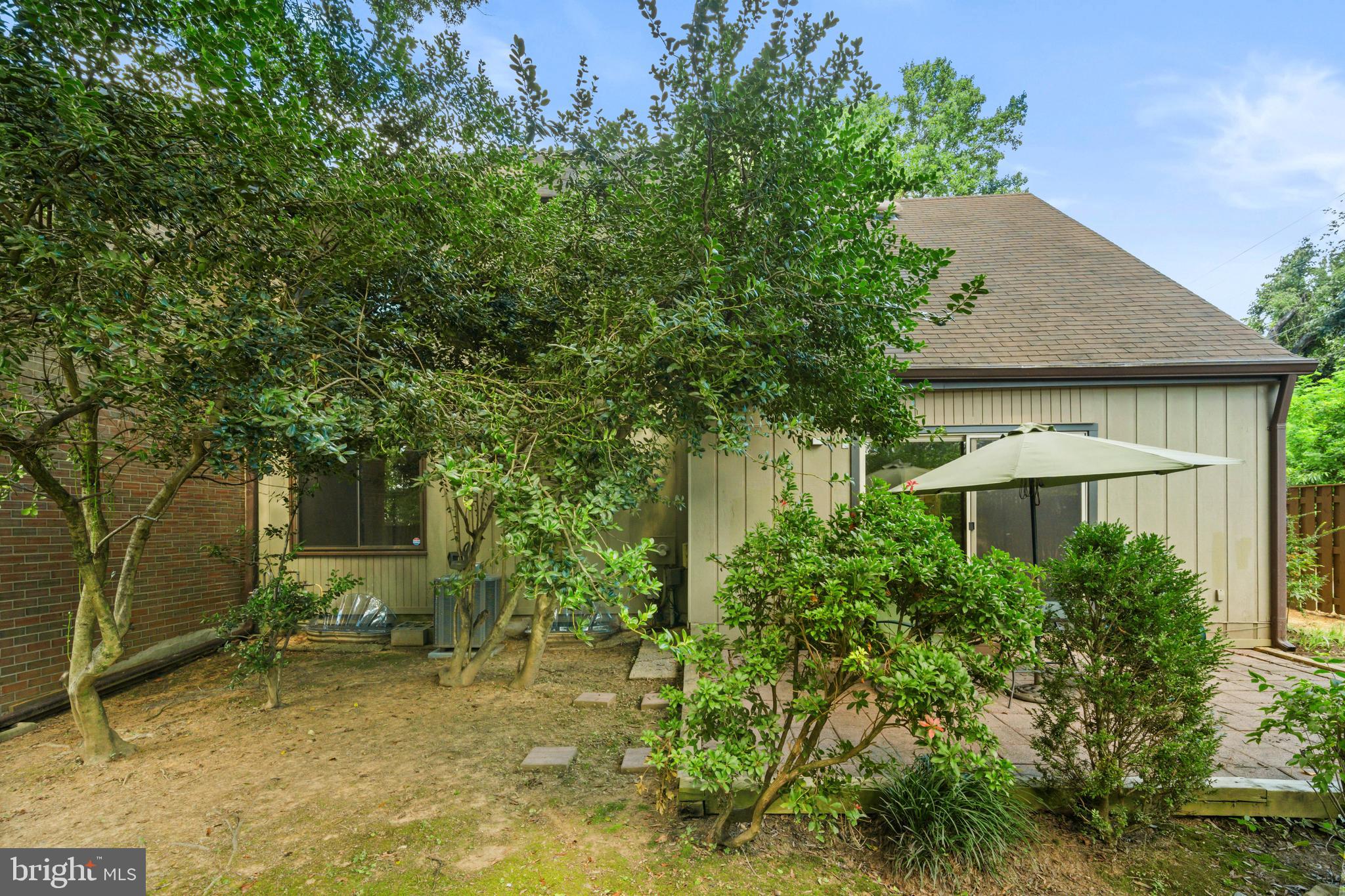 1413 Green Run Lane Reston, VA 20190 - Photo 35 of 50 a backyard of a house with plants and large tree