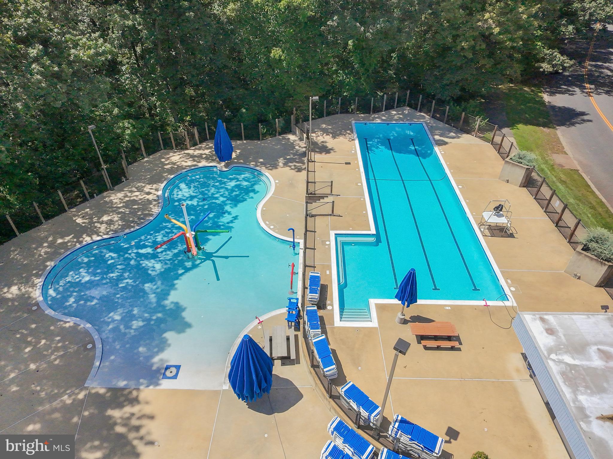 1413 Green Run Lane Reston, VA 20190 - Photo 48 of 50 a view of a swimming pool with a patio