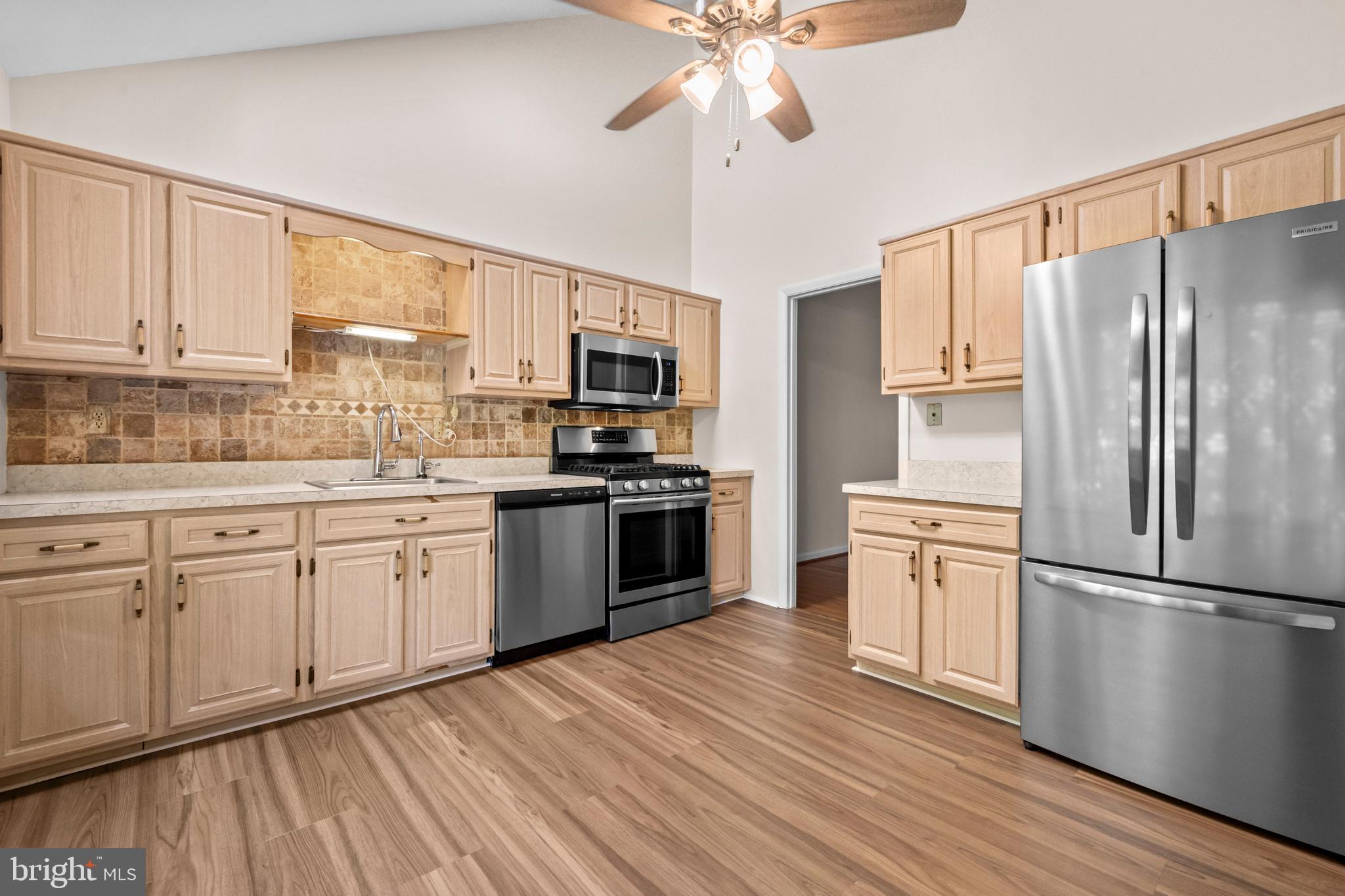 1413 Green Run Lane Reston, VA 20190 - Photo 7 of 50 a kitchen with a refrigerator cabinets and wooden floor