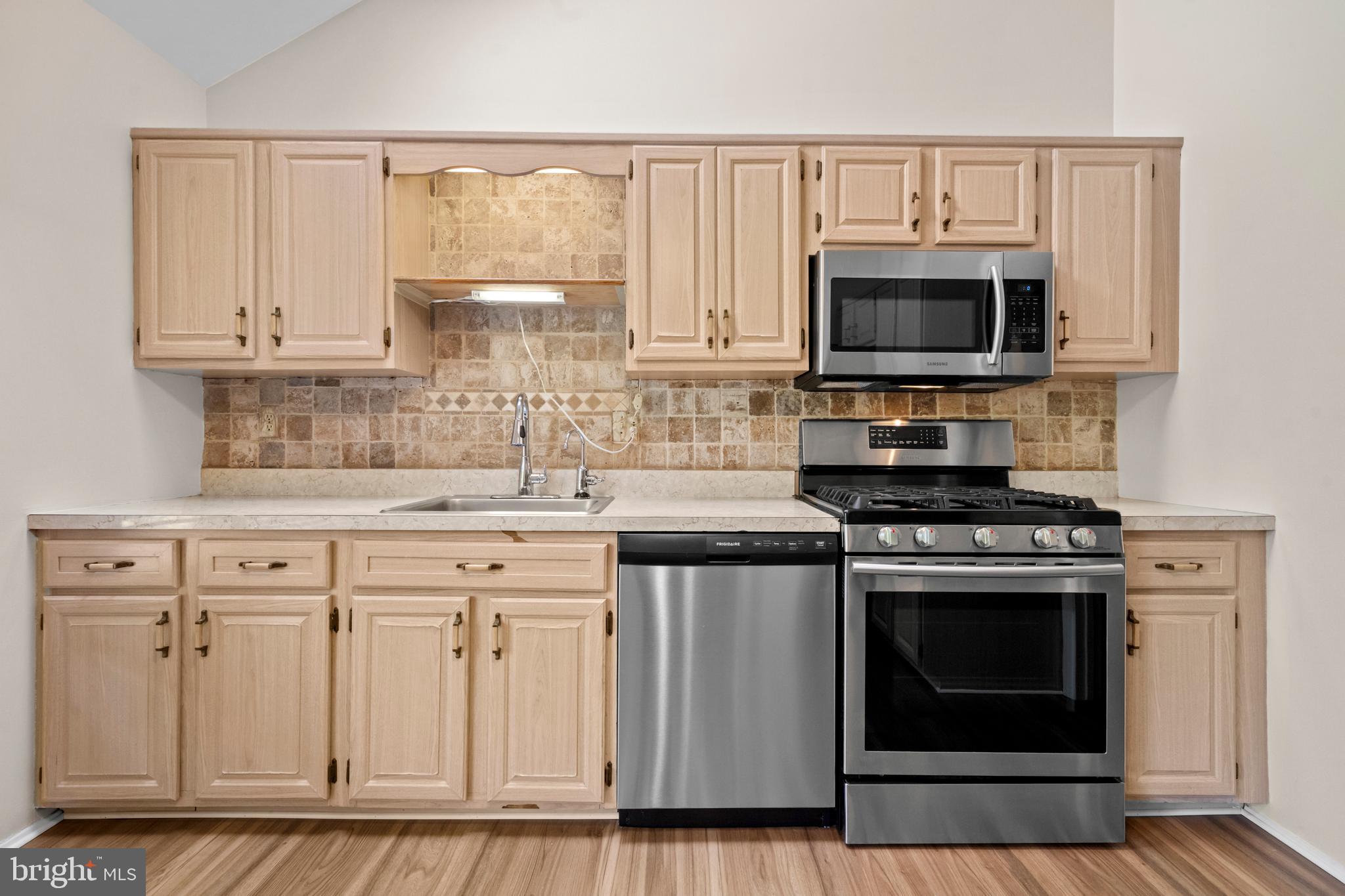 1413 Green Run Lane Reston, VA 20190 - Photo 8 of 50 a kitchen with white cabinets and stainless steel appliances