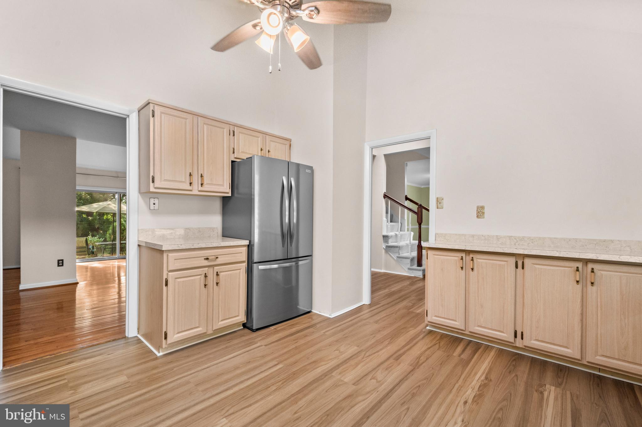 1413 Green Run Lane Reston, VA 20190 - Photo 10 of 50 a kitchen with stainless steel appliances a refrigerator and wooden floor