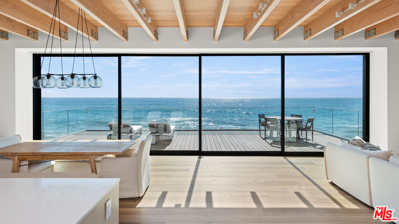 24604 Malibu Road Malibu, CA 90265 - Photo 1 of 17 a view of a floor to ceiling window with a table and chairs